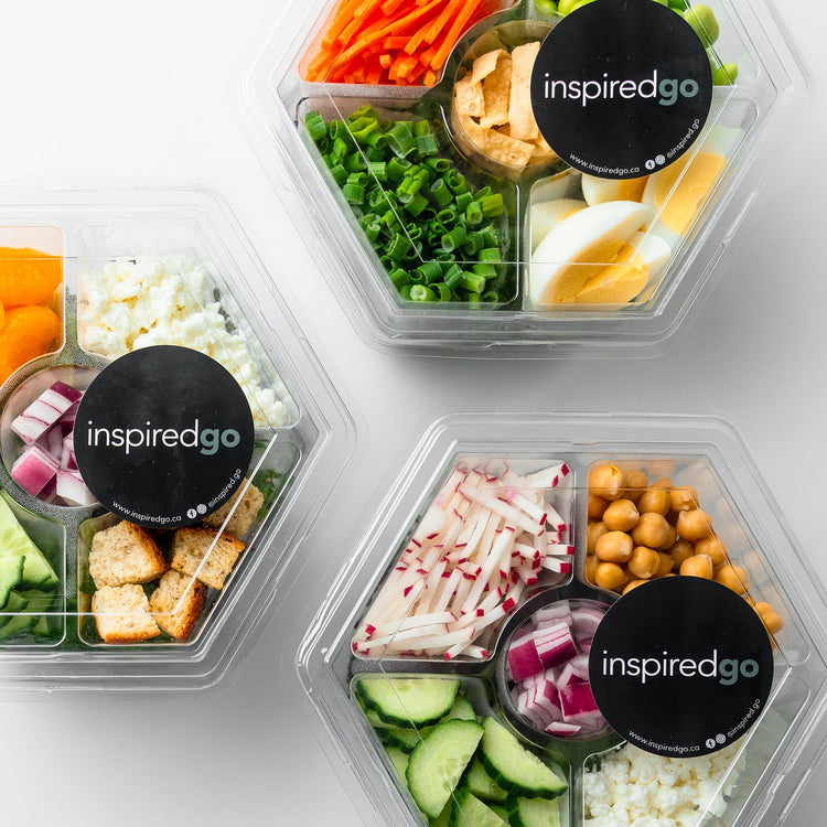 Hexagonal containers with assorted vegetables and ingredients, branded 'inspired go'.