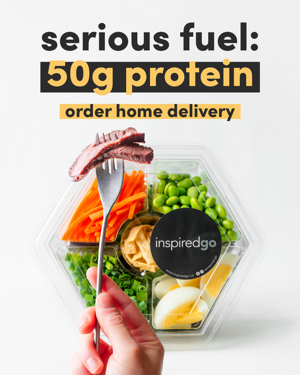 Hand holding fork with steak over Inspired Go salad container, highlighting 50 grams of protein and promoting home delivery.