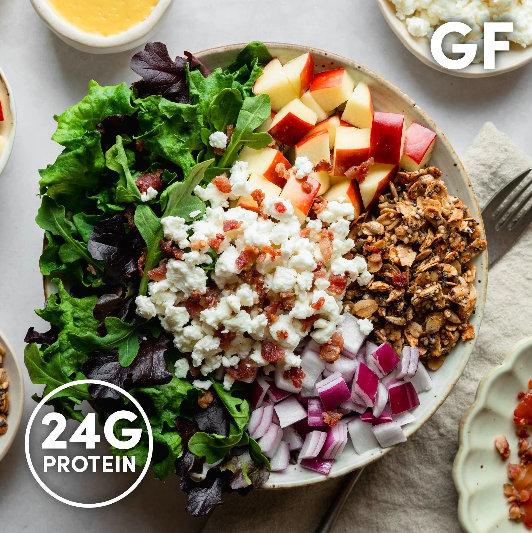 Overhead image of InspiredGo salads made with leafy greens, grains, and fresh toppings like chickpeas, eggs, and roasted vegetables — a high-fiber, protein-rich meal option.