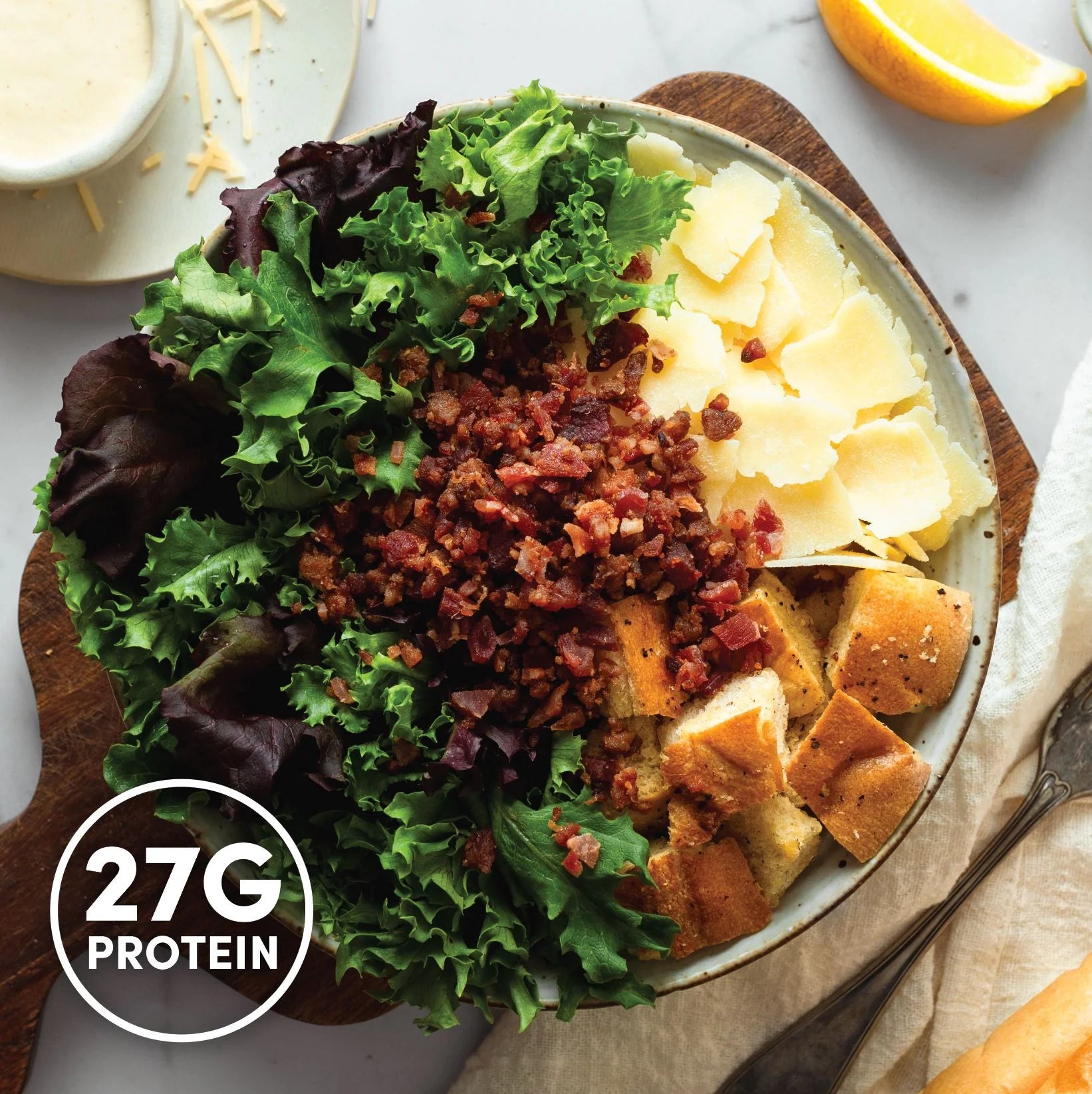 Overhead image of InspiredGo salads made with leafy greens, grains, and fresh toppings like chickpeas, eggs, and roasted vegetables — a high-fiber, protein-rich meal option.